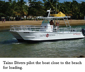 Taino Divers pilot the boat close to the beach for loading.