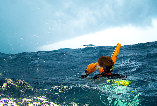 A diver with safety sausage and flashlight beam as surface markers