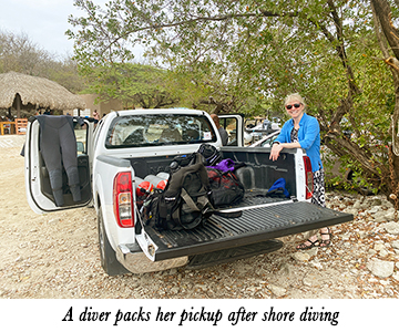 A diver packs her pickup after shore diving
